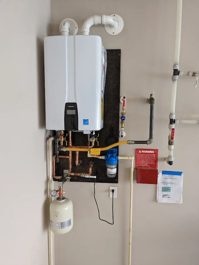 Professional plumber installing copper piping in a Union Beach home